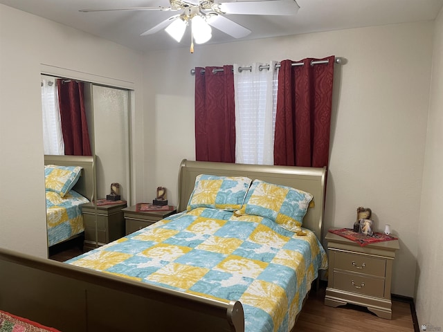 bedroom featuring ceiling fan, dark hardwood / wood-style flooring, and a closet