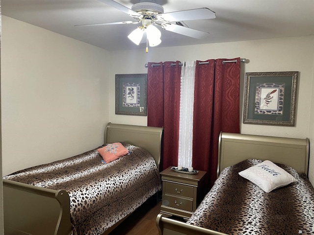 bedroom with dark wood-type flooring and ceiling fan