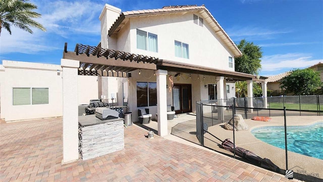 back of property featuring a fenced in pool, fence, a patio, and stucco siding