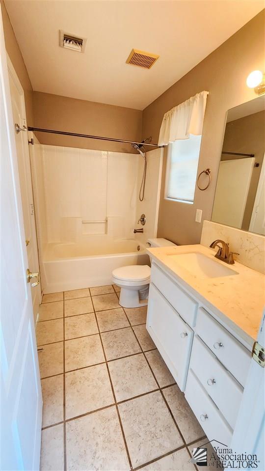 full bath with tile patterned flooring, visible vents, vanity, and toilet