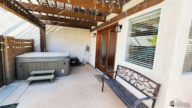 view of patio / terrace with a pergola and a hot tub