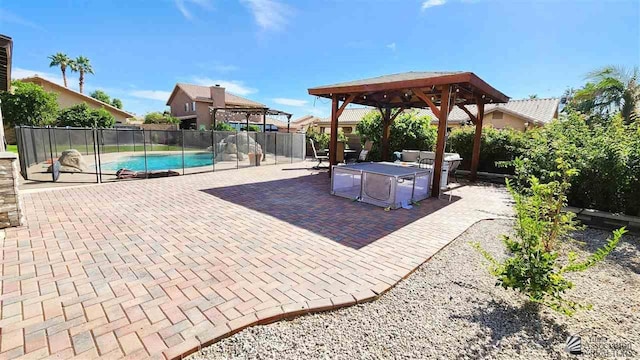 view of patio / terrace with a gazebo, fence, and a fenced in pool