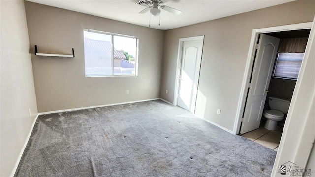 unfurnished bedroom with a ceiling fan, carpet flooring, baseboards, and ensuite bathroom