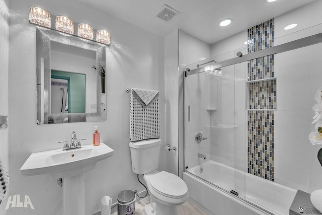 bathroom with enclosed tub / shower combo, toilet, and visible vents