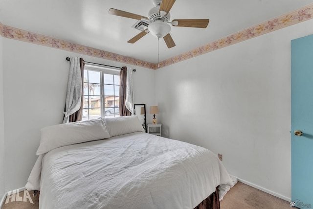 carpeted bedroom with ceiling fan and baseboards