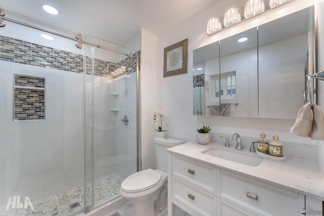 full bathroom featuring toilet, a stall shower, recessed lighting, and vanity