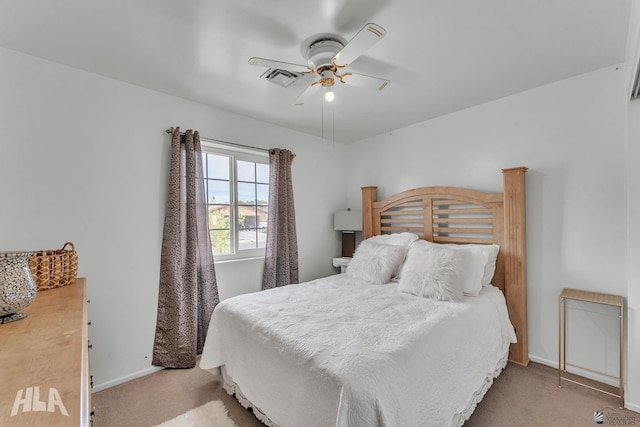 bedroom with light carpet, baseboards, visible vents, and a ceiling fan