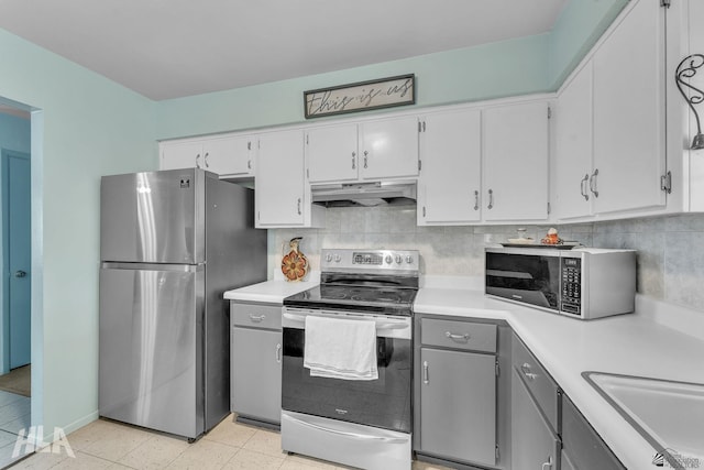 kitchen featuring stainless steel appliances, backsplash, light countertops, and under cabinet range hood