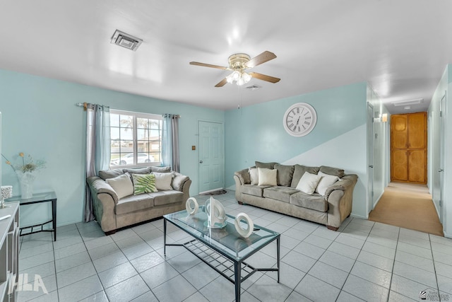 living room featuring a ceiling fan, visible vents, and light tile patterned flooring