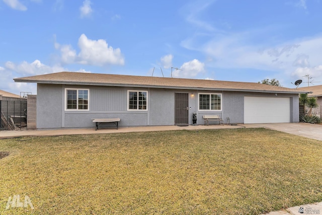 ranch-style house with a garage, a front yard, driveway, and stucco siding