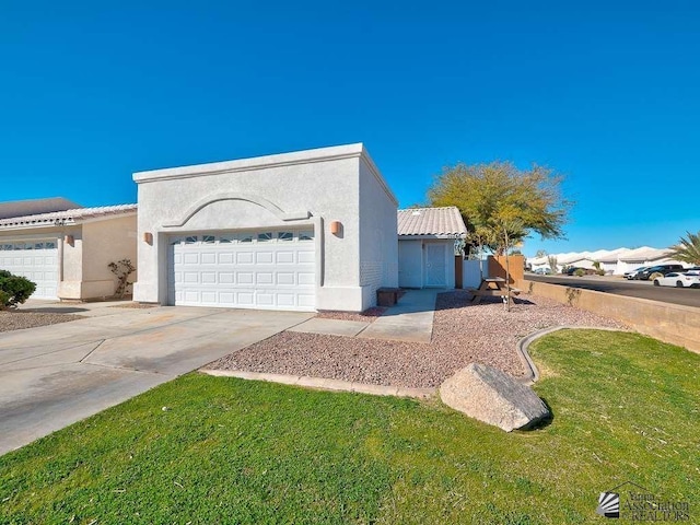 view of front of home with a garage and a front lawn