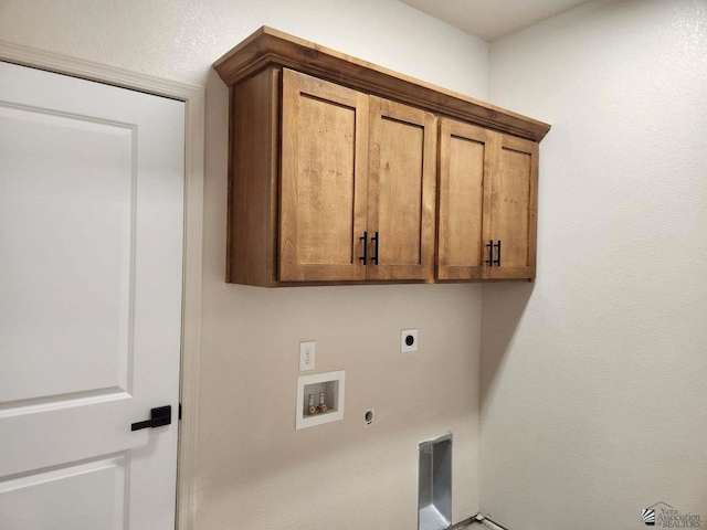 clothes washing area with cabinets, hookup for a washing machine, gas dryer hookup, and hookup for an electric dryer