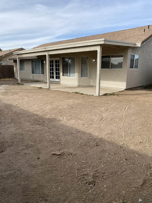 rear view of property featuring french doors and a patio area