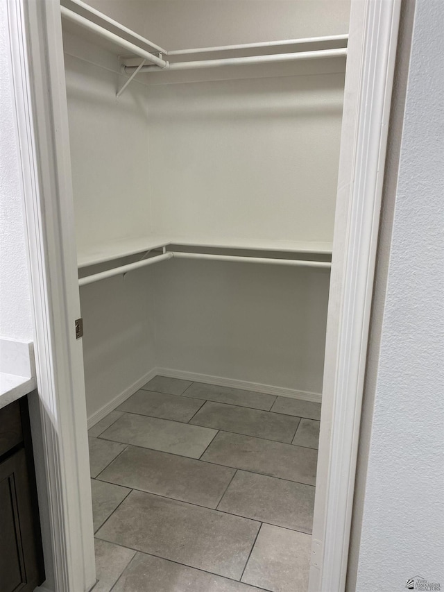 walk in closet featuring light tile patterned floors