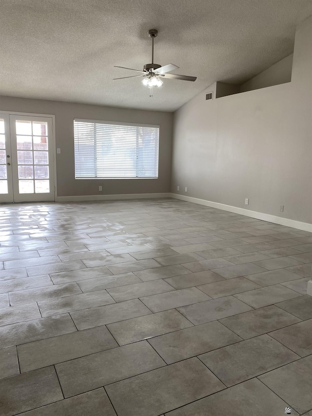 unfurnished room featuring a textured ceiling, vaulted ceiling, and ceiling fan