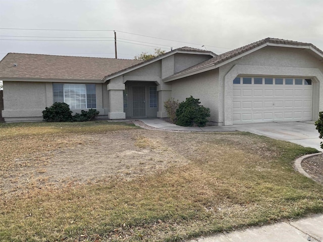 single story home featuring a garage and a front lawn