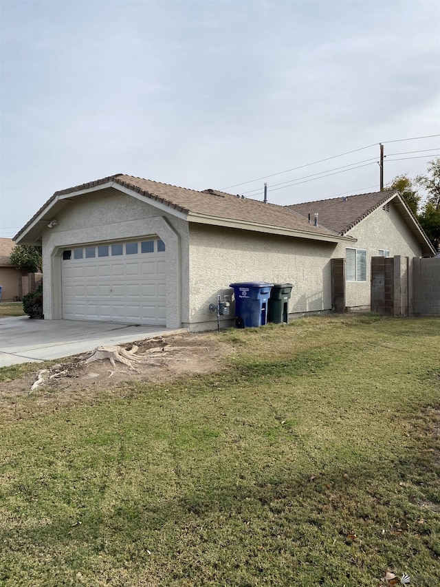 view of home's exterior featuring a lawn and a garage