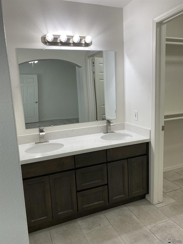 bathroom featuring tile patterned flooring and vanity