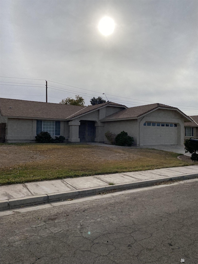 view of front of property featuring a garage and a front lawn