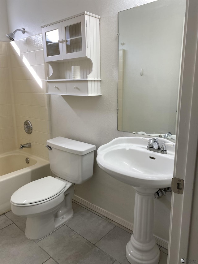 bathroom featuring tile patterned flooring, shower / bathing tub combination, and toilet