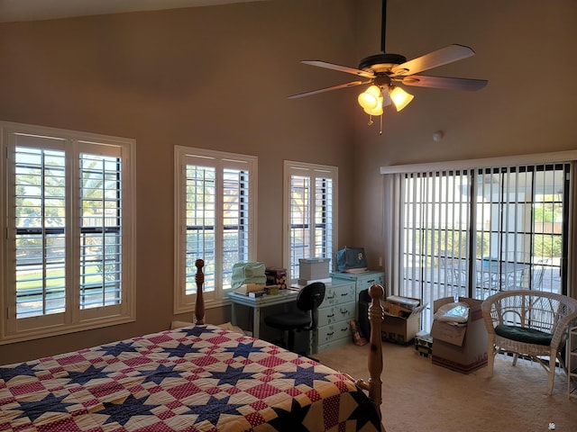 carpeted bedroom with ceiling fan and high vaulted ceiling