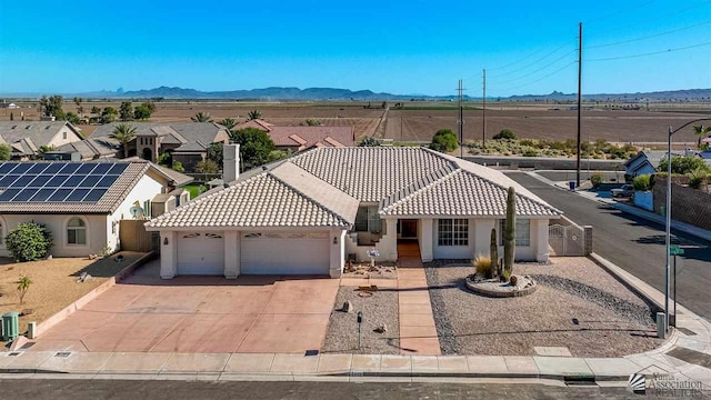 view of front of home with a mountain view and a garage