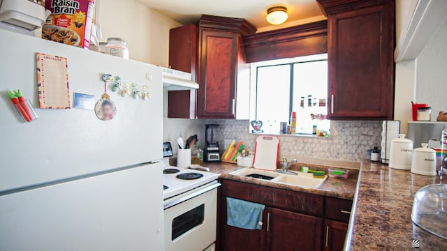 kitchen with sink, white appliances, and backsplash