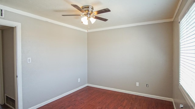 spare room with crown molding, ceiling fan, and dark wood-type flooring