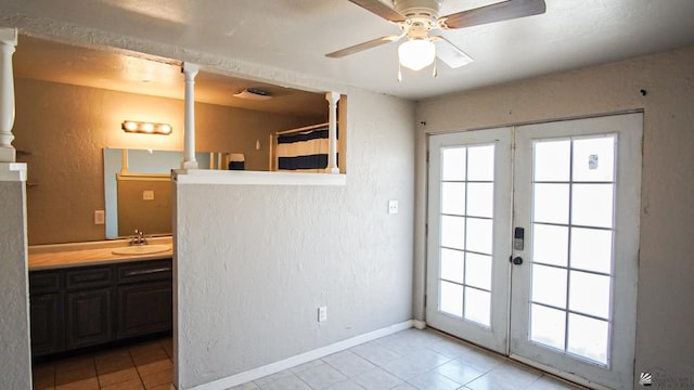 doorway with ceiling fan, light tile patterned floors, sink, and french doors