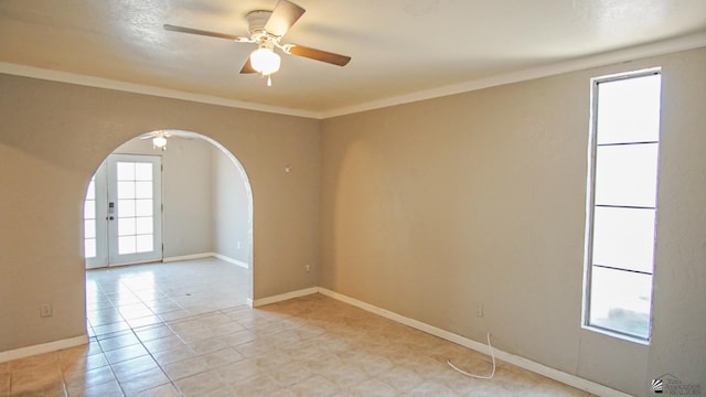 unfurnished room with ceiling fan and crown molding