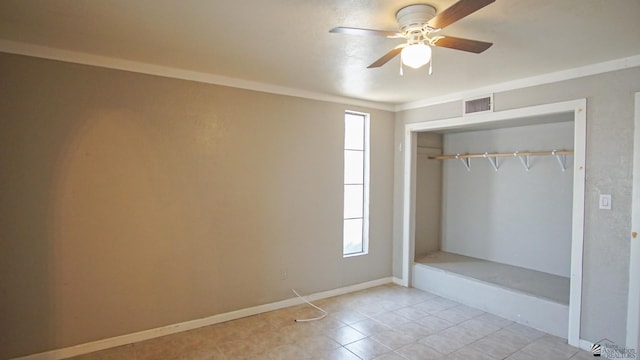 interior space featuring light tile patterned floors, a closet, ceiling fan, and ornamental molding