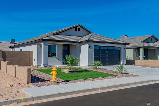 ranch-style home with a front lawn and a garage