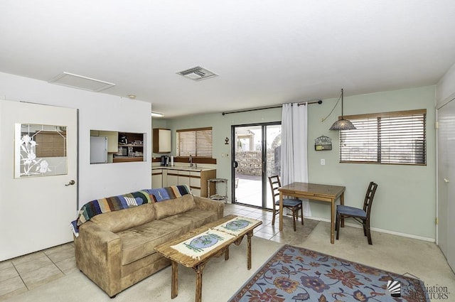 living room with sink and light tile patterned floors