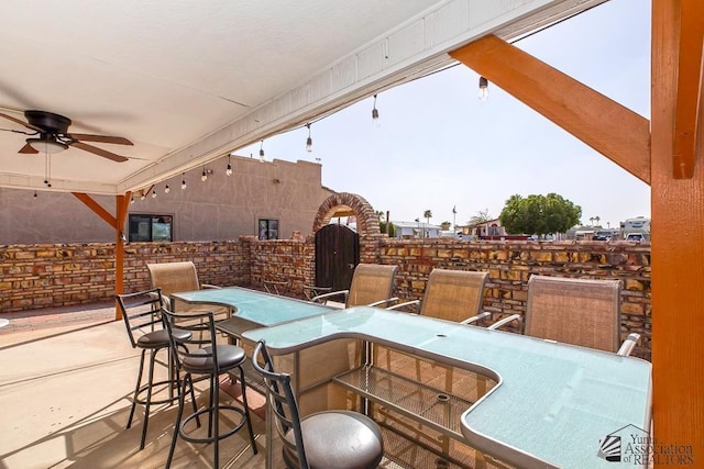 view of patio / terrace with a bar and ceiling fan