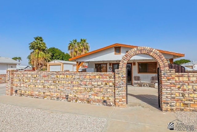 view of front of property featuring a garage and an outdoor structure