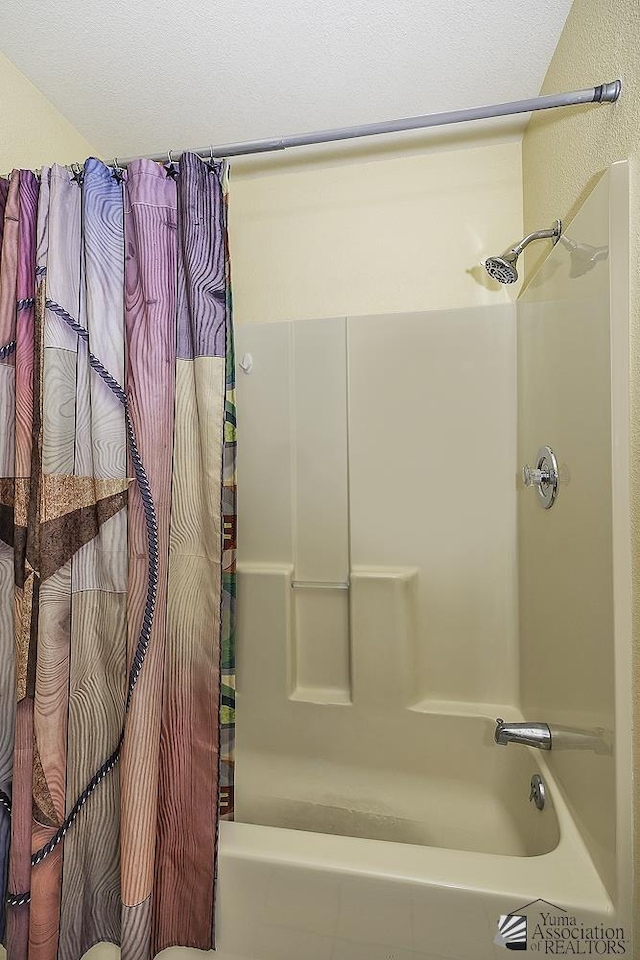 bathroom featuring shower / bathtub combination with curtain