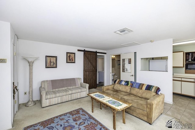 tiled living room featuring a barn door