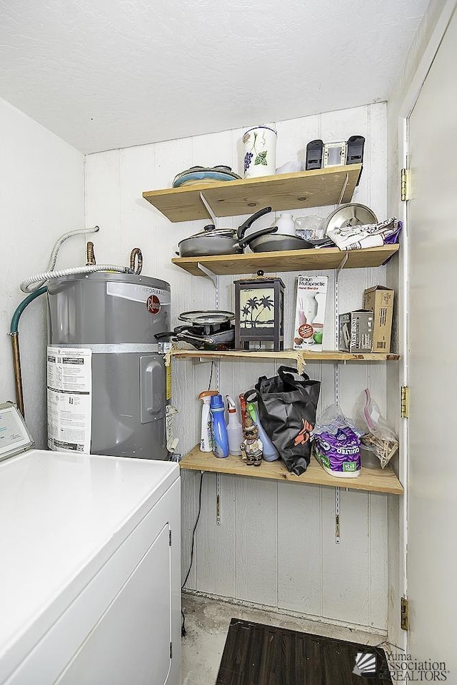 clothes washing area with washer / clothes dryer and electric water heater