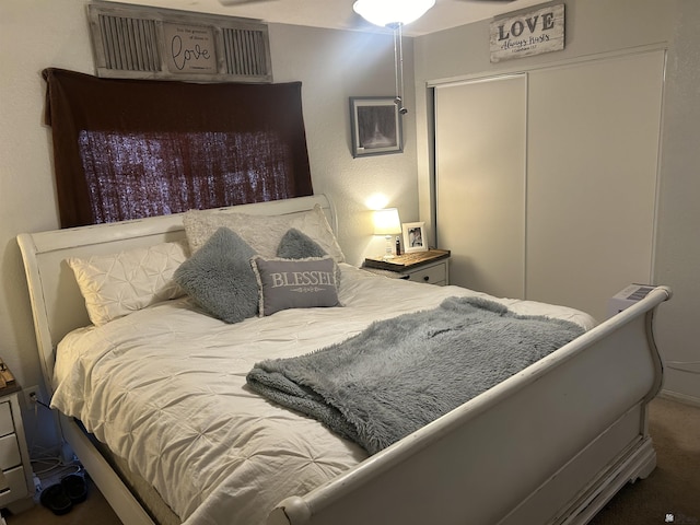 bedroom with a closet and dark carpet