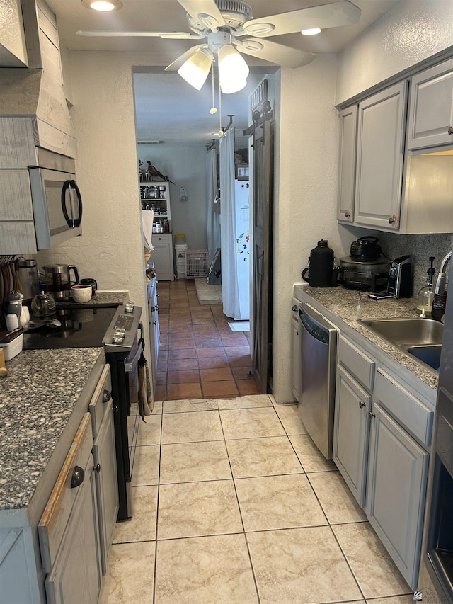 kitchen with ceiling fan, gray cabinets, sink, appliances with stainless steel finishes, and light tile patterned floors