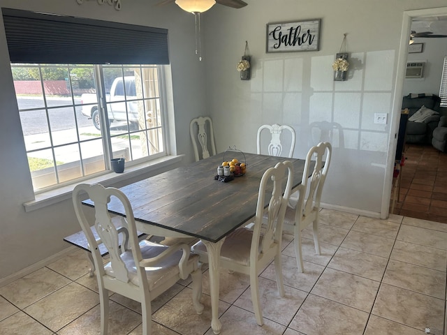 tiled dining area featuring ceiling fan and a wall mounted air conditioner