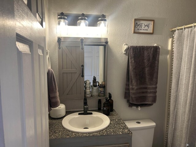 bathroom featuring toilet and vanity