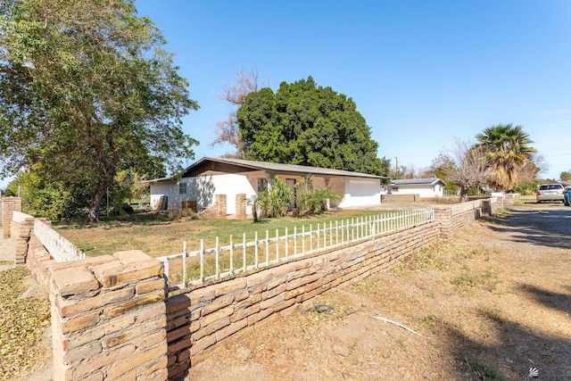 ranch-style home featuring fence