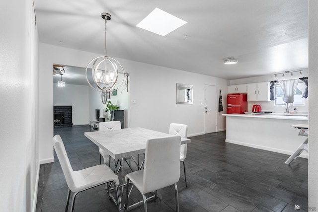 dining area with a brick fireplace, baseboards, and dark wood-style flooring