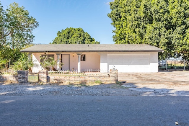 single story home with a garage, driveway, fence, and stucco siding