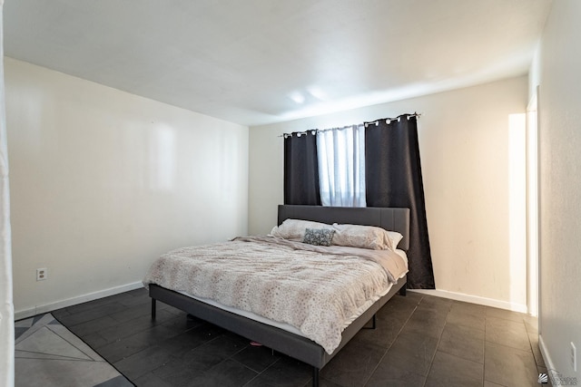 bedroom featuring baseboards