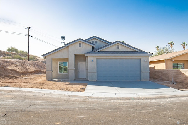 view of front of house with a garage, fence, concrete driveway, and stucco siding