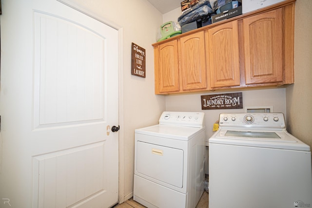 washroom featuring cabinets and washing machine and dryer