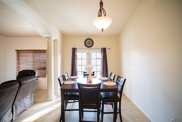 dining area with light tile patterned floors and ornate columns