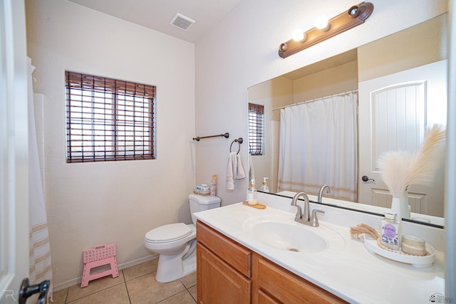 bathroom featuring tile patterned floors, vanity, and toilet